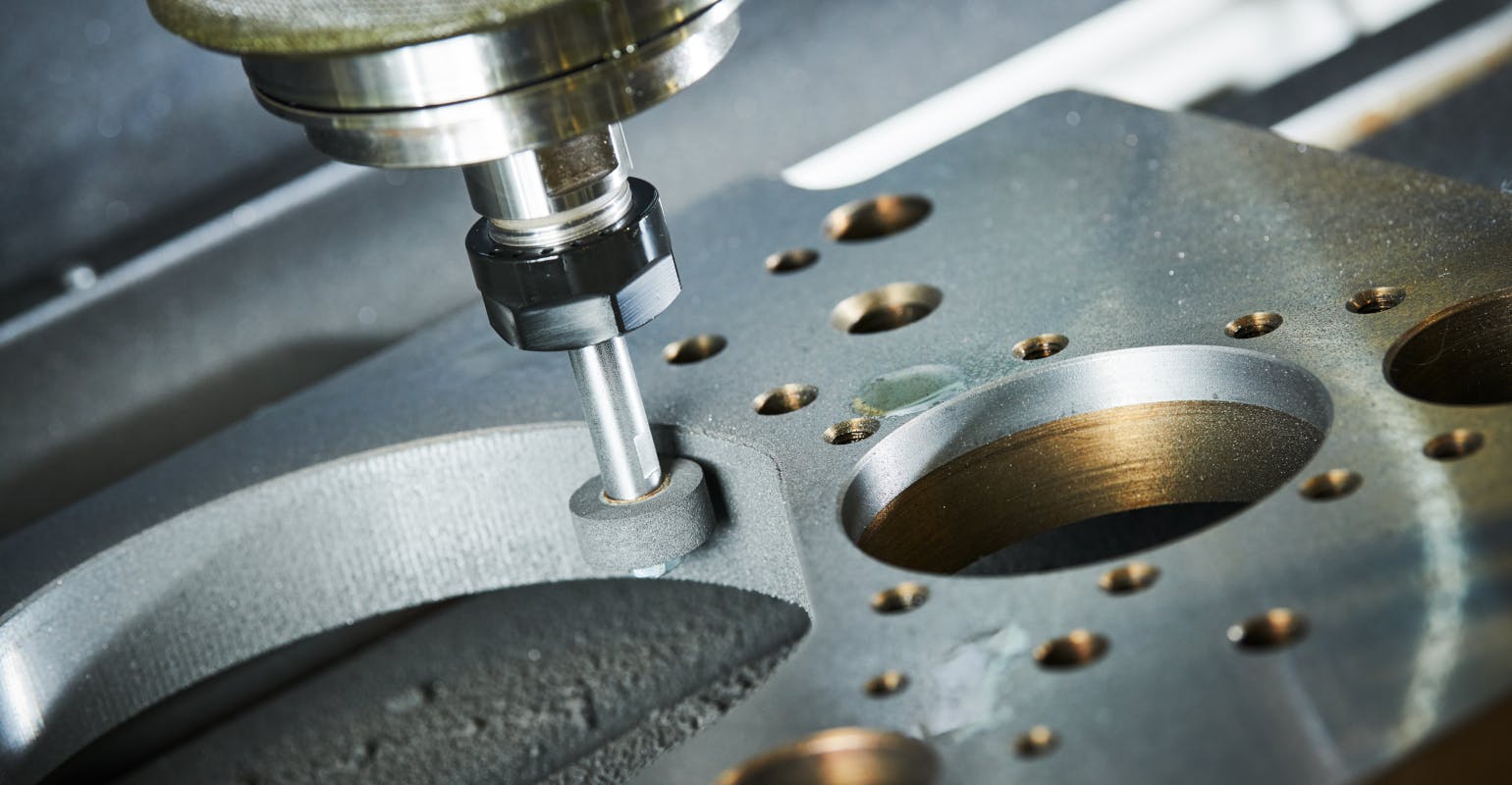 Grinding metal on a CNC machine.