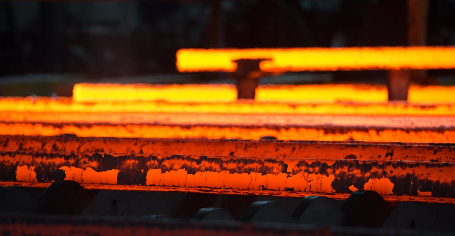 Con cast steel billets on a run-out table.