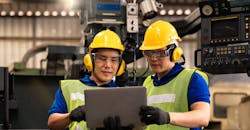 Technicians / engineers inspecting machine operations using a laptop computer. Technicians / engineers inspecting machine operations using a laptop computer.