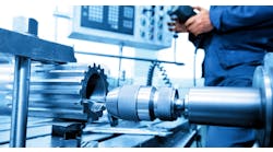 Man operating CNC drilling and boring machine. Man operating CNC drilling and boring machine.