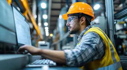 Industrial engineer overseeing production processes and monitoring advanced machinery.