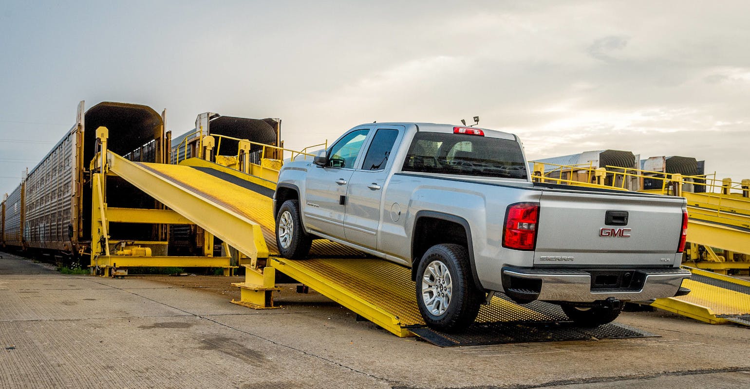 A 2014 GMC Sierra pickup is loaded onto a train car for shipping Wednesday, July 31, 2013 at the General Motors Fort Wayne Assembly plant in Fort Wayne, Indiana.