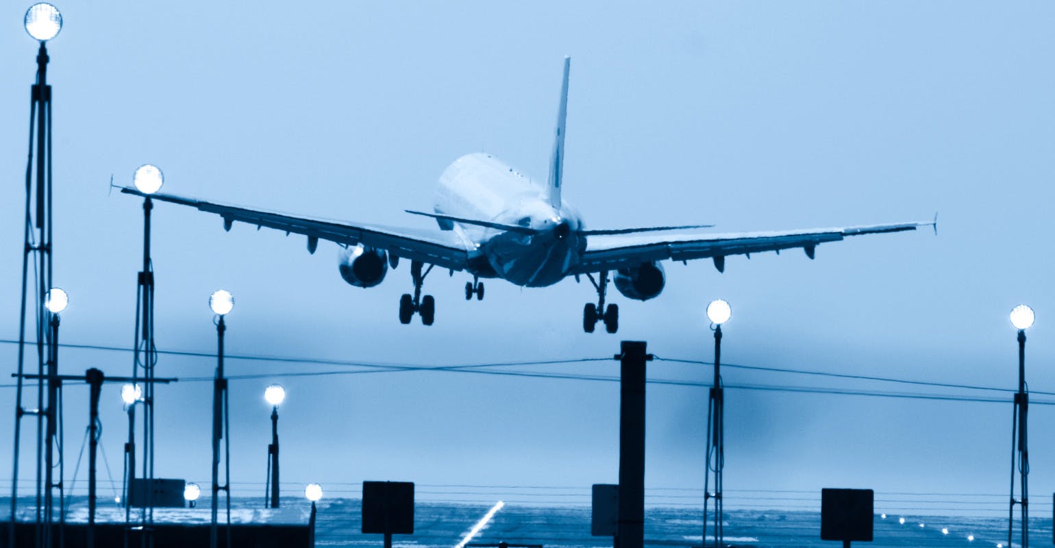 Blue-toned image of aircraft at takeoff.