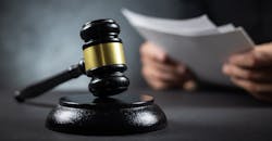 Judge reviews a record. Judge reviews a record.