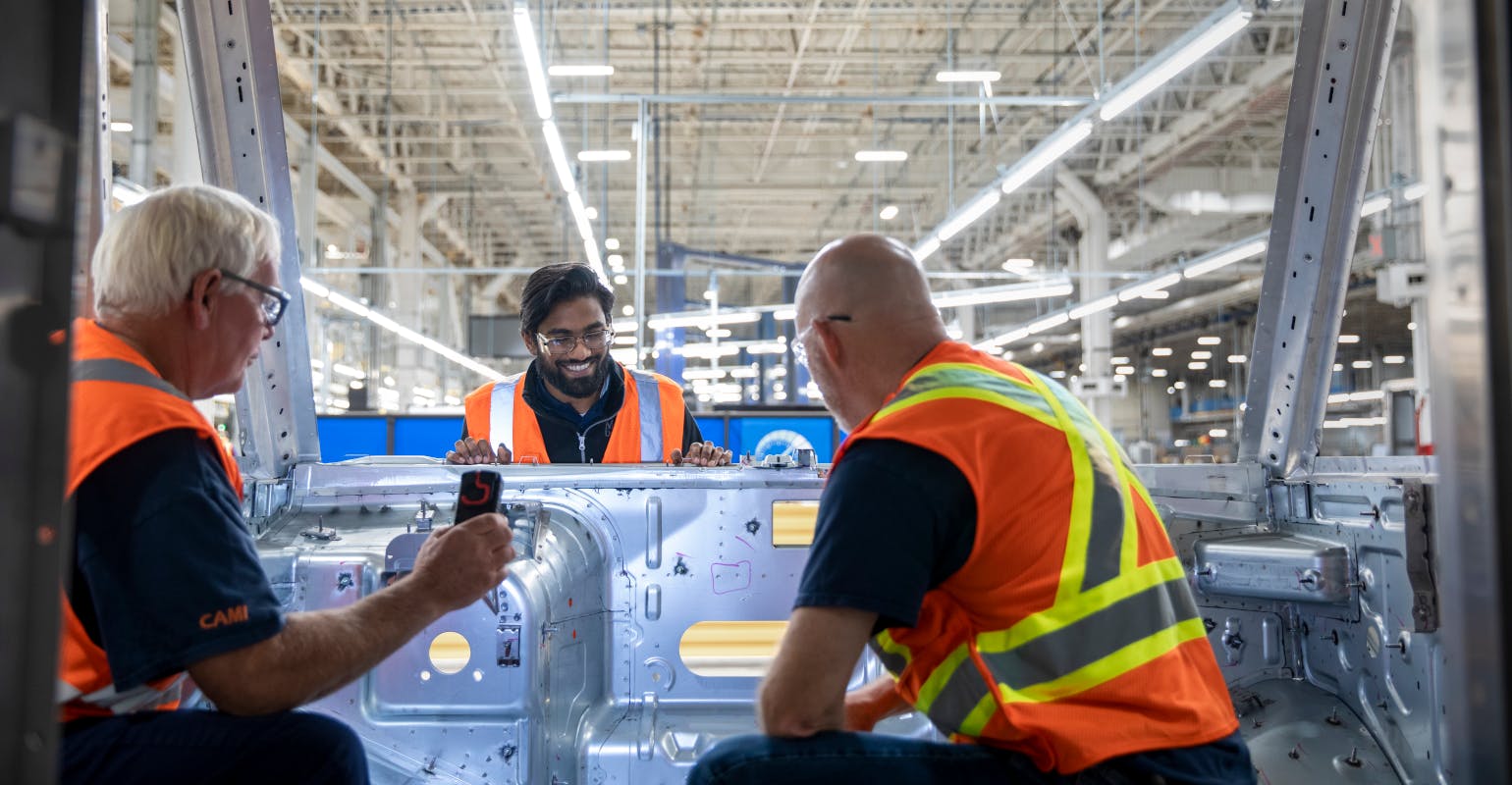 Employees work on the BrightDrop Zevo 600 production line at CAMI Assembly, Canada&rsquo;s first full-scale EV plant.
