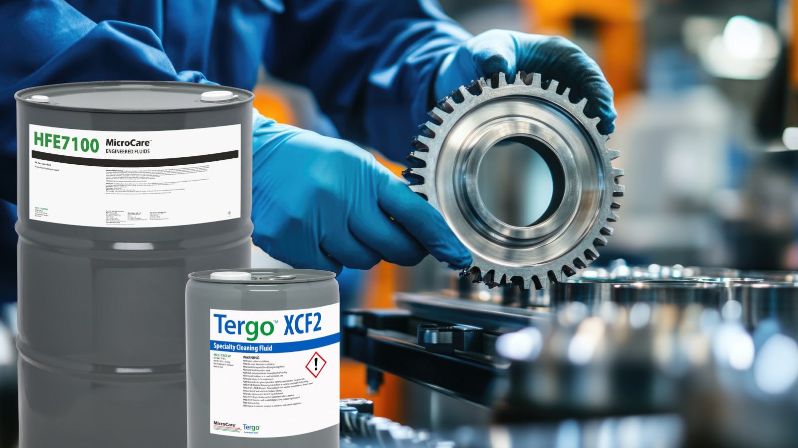 Barrels of MicroCare's specialty fluids are superimposed on the image of a gloved machinist cleaning a gear.