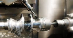 Metal workpiece being processed on a drilling machine. Metal workpiece being processed on a drilling machine.