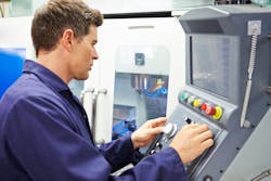 Engineer operating CNC milling machine Engineer operating CNC milling machine