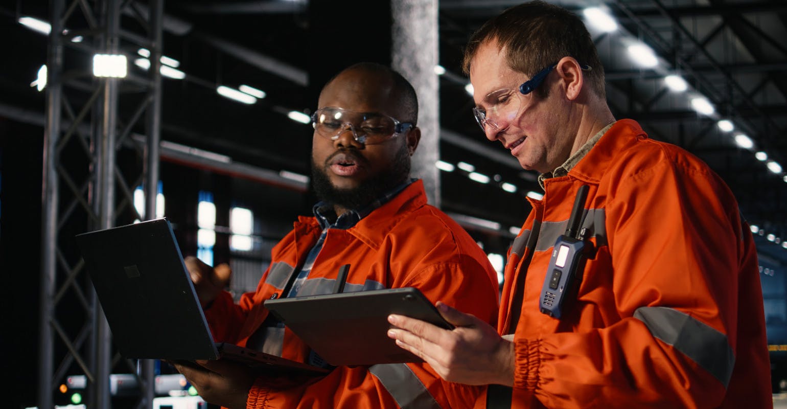 Employee team guides manufacturing duties.