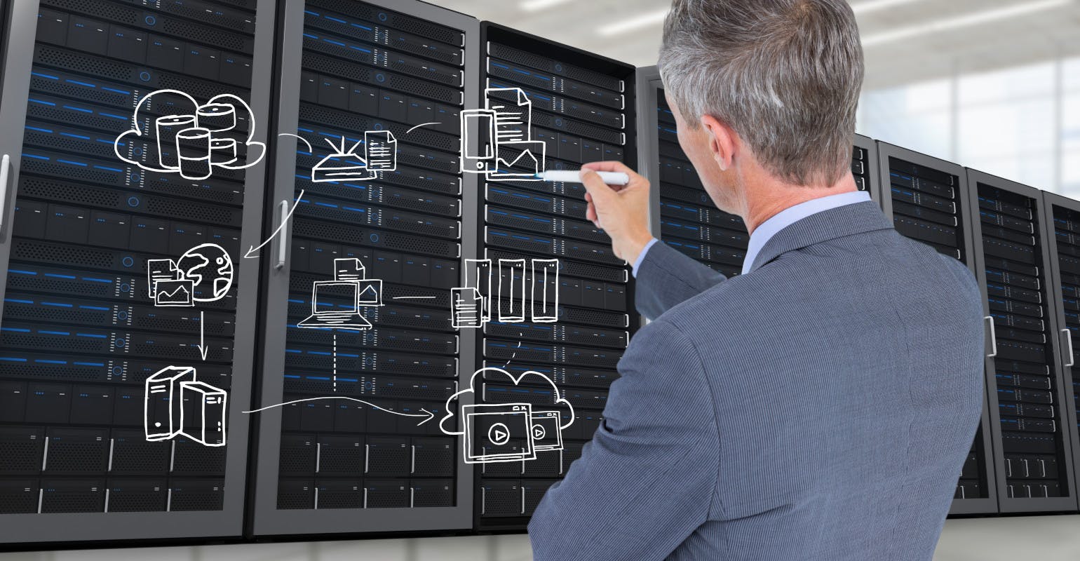 Businessman thinking, planning at a data center.