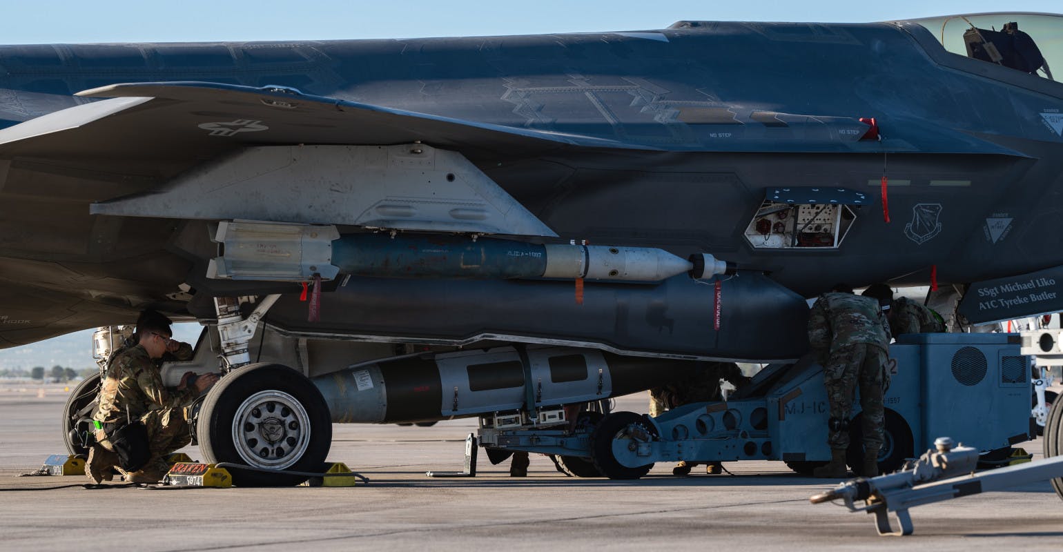 Aircraft armament systems specialists load weapons on an F-35A Lightning II.