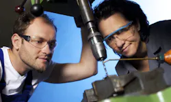 Technicians at a drilling machine. Technicians at a drilling machine.