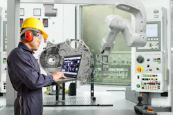 Engineer using laptop computer control and robotic hand with CNC machine in automotive industry. Engineer using laptop computer control and robotic hand with CNC machine in automotive industry.