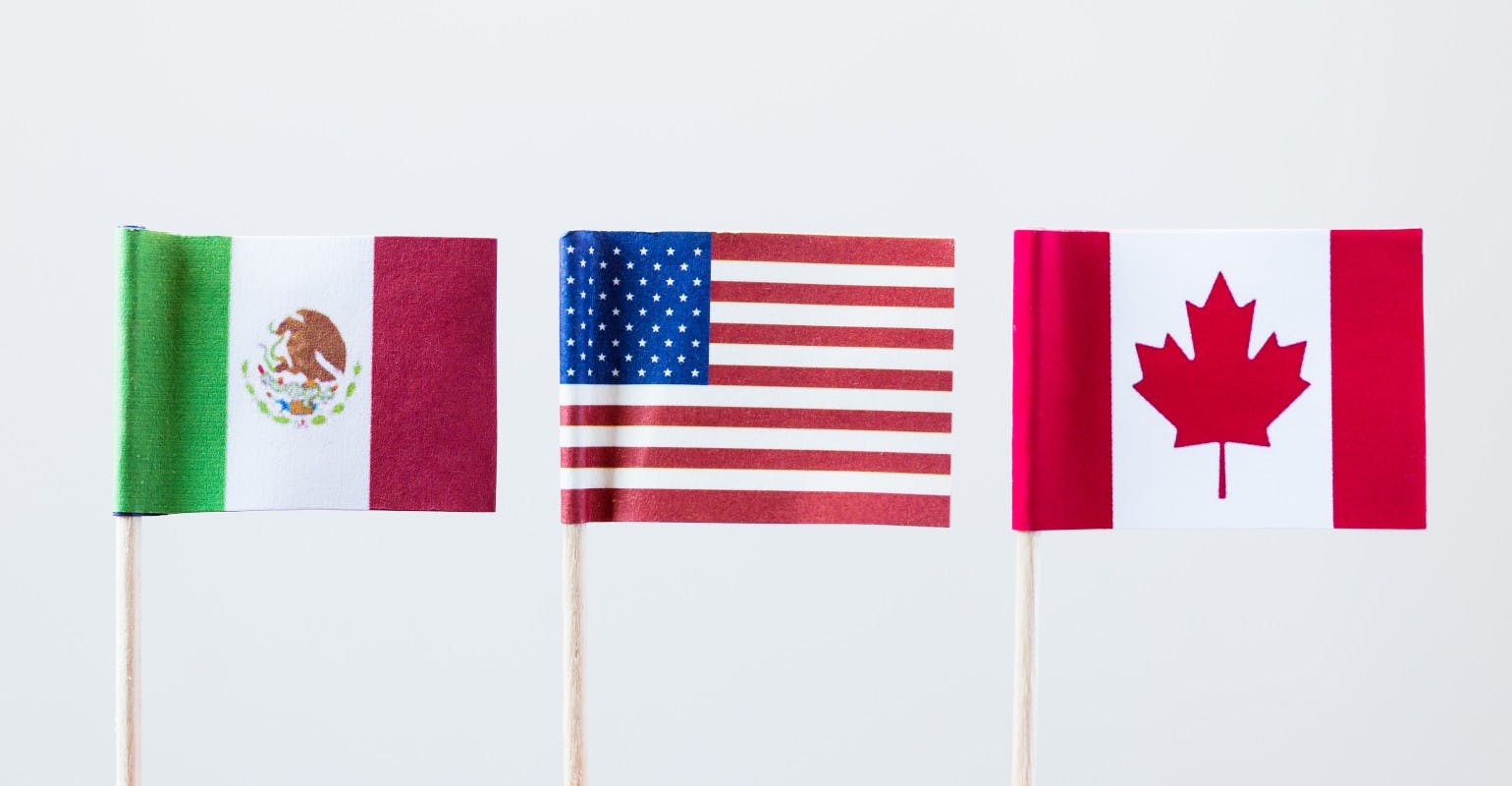 The flags of the three USMCA member countries.