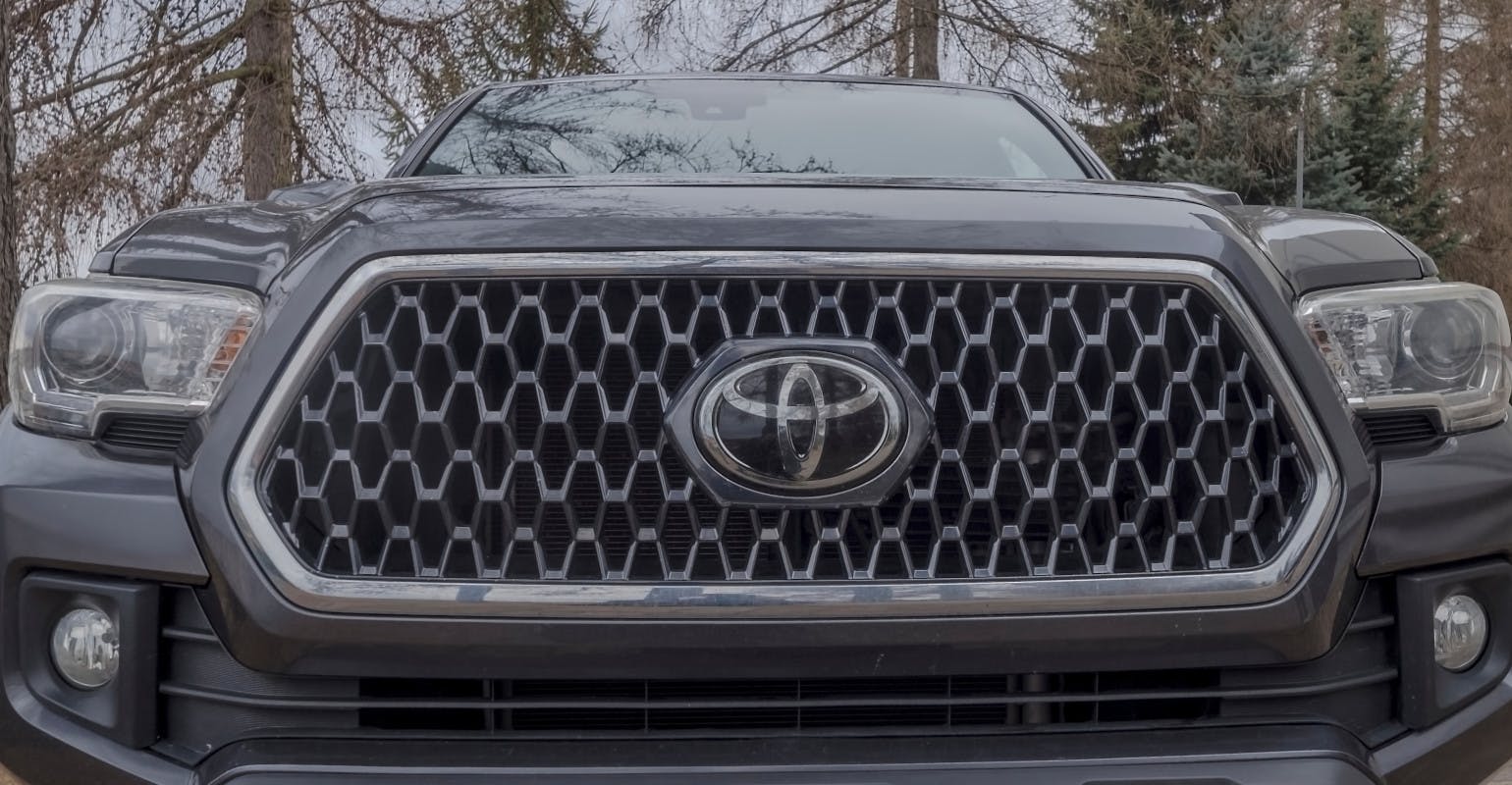 Toyota Tacoma pickup truck, with prominent grille and Toyota logo.