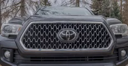 Toyota Tacoma pickup truck, with prominent grille and Toyota logo.