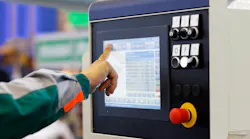 Operator prepares CNC machine for new task.