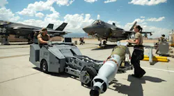 U.S. Air Force Staff Sgt. Jessika Steele, right, and Senior Airman Immanuel Bailey, left, transport a GBU-12 Paveway II bomb to load on to an F-35 Lightning II at Nellis Air Force Base, Nevada, Aug. 11, 2023.