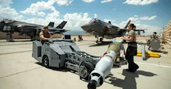 U.S. Air Force Staff Sgt. Jessika Steele, right, and Senior Airman Immanuel Bailey, left, transport a GBU-12 Paveway II bomb to load on to an F-35 Lightning II at Nellis Air Force Base, Nevada, Aug. 11, 2023.